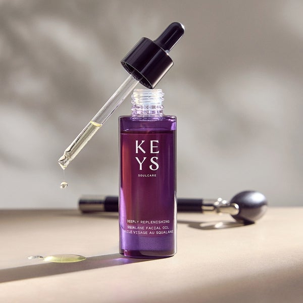 Deeply Replenishing Squalane Facial Oil being used with a facial roller